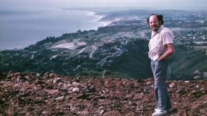 Paul Spudich standing on hillside